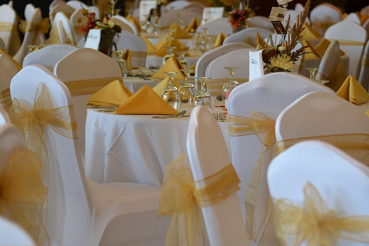 view of banquet table setting with gold accents